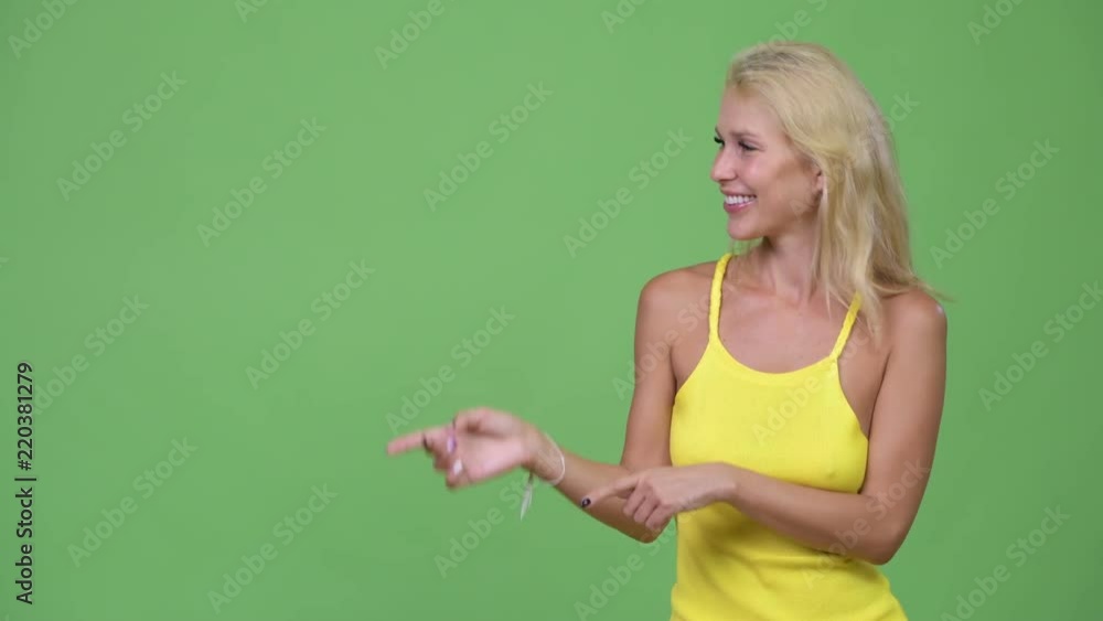 Young happy beautiful blonde woman showing something Young happy beautiful blonde woman showing something