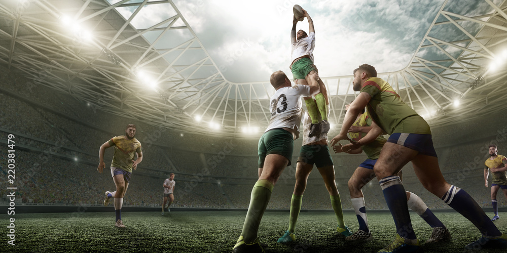 Fotografia Rugby players fight for the ball on professional rugby stadium  su EuroPosters.it