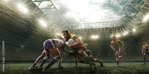 Rugby players fight for the ball on professional rugby stadium © Alex