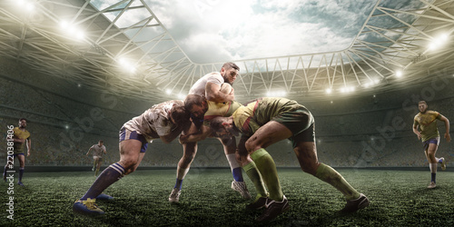Rugby players fight for the ball on professional rugby stadium photo