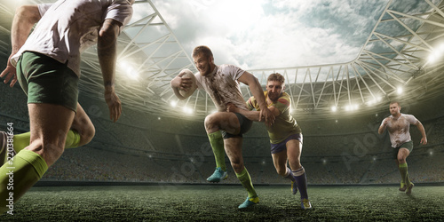 Fototapeta Rugby players fight for the ball on professional rugby stadium