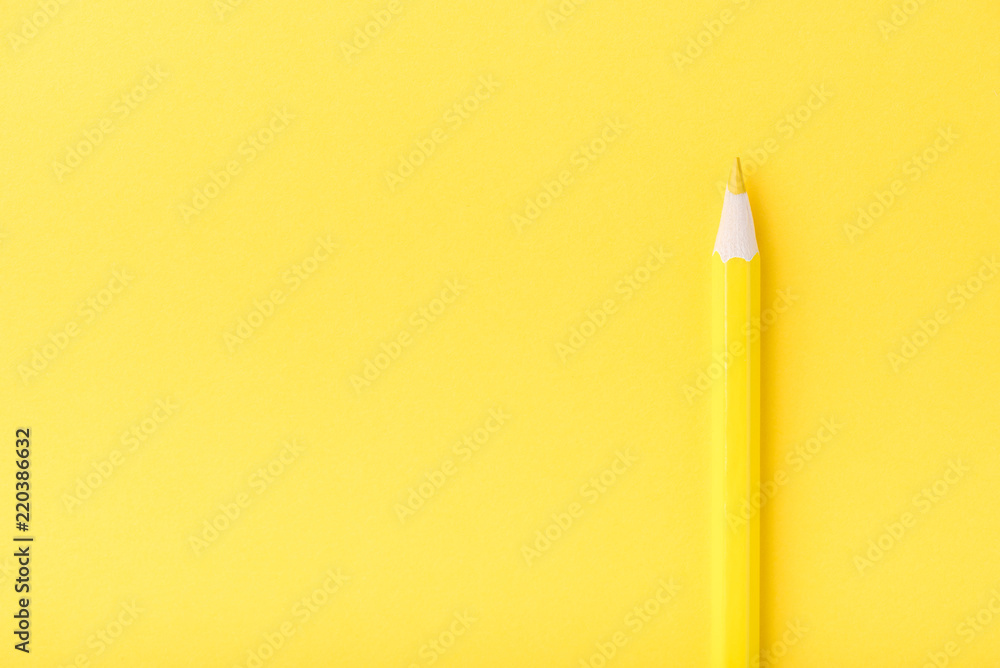 Macro photograph of several pencils of yellow and orange color on a paper background Macro photograph of several pencils of yellow and orange color on a paper background