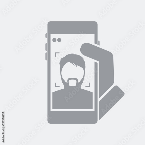 Smartphone take a photo to a bearded boy