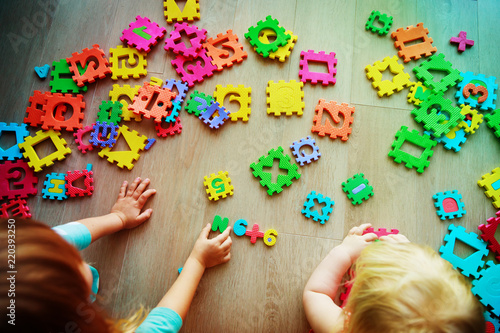 kids playing with puzzle, learning numbers and shapes