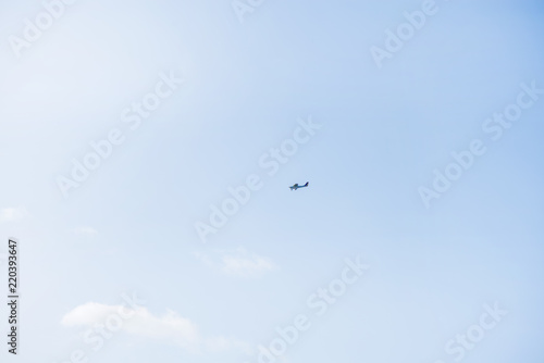 Military helicopters flying in the sky over a city and crowded event, taking photos, filming from above on clear blue sky background. An Isolated helicopter. Team of rescuers searching for lost people