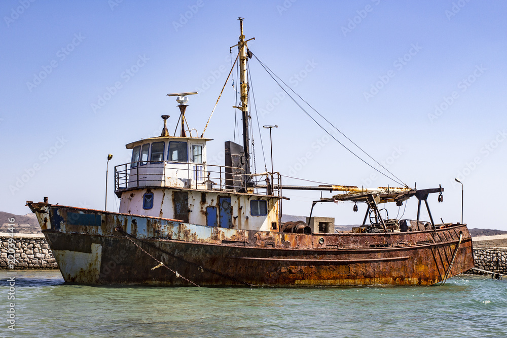 Old rusty ship in the harbor. Ghost boat