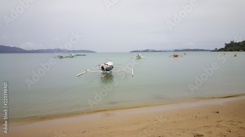 Bangka boat in front of tropical island near Port Barton, Philippines