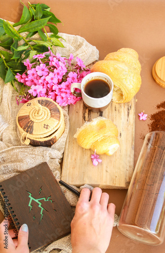 Flat lay composition with cup of coffee,croissants and hands.
