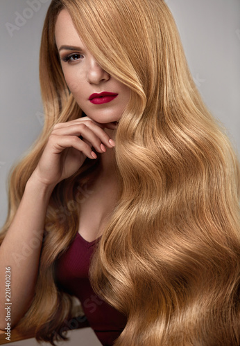 Hair Style. Beautiful Woman With Healthy Wavy Long Blonde Hair