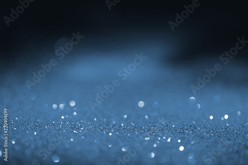 blurred blue glowing glitter on black background