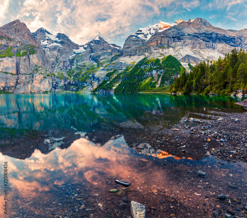 Colorful summer sunrise on the unique Oeschinensee Lake