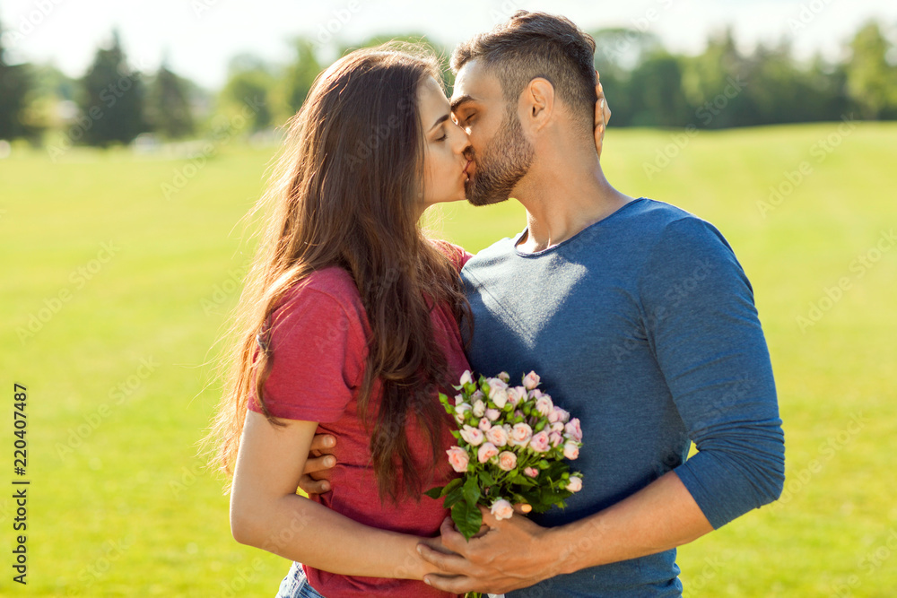 couple in love hugging in the park, concept of Valentine's Day couple in love hugging in the park, concept of Valentine's Day
