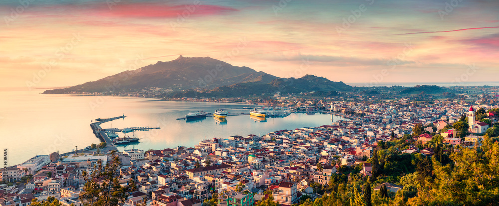 Aerial view of Zakynthos (Zante) town. Colorful spring sunrise on the Ionian Sea. Beautiful cityscape panorama of Greece city. Traveling concept background. Artistic style post processed photo. - obrazy, fototapety, plakaty 
