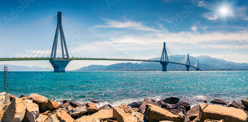 Fototapeta Naklejka Na Ścianę i Meble -  Sunny morning panorama of Rion-Antirion Bridge. Colorful spring view of the Gulf of Corinth, Greece, Europe. Beauty of countryside concept background. Artistic style post processed photo.