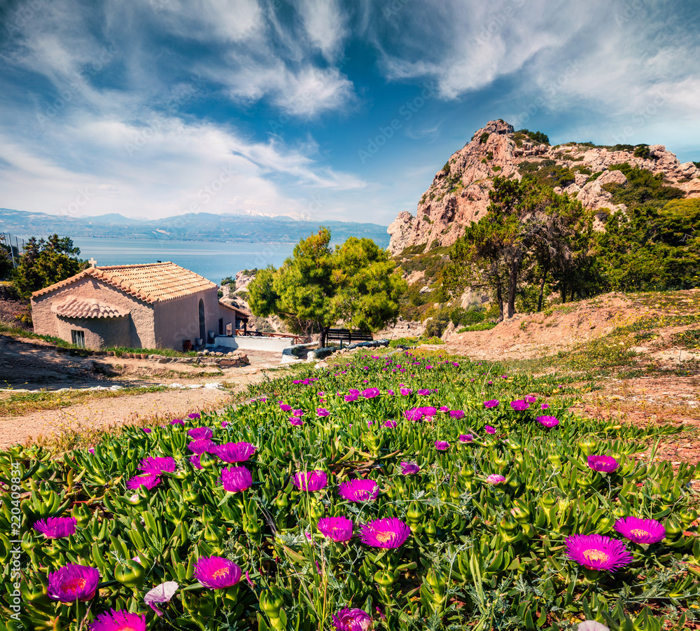Sunny spring view of Agios Ioannis Church. Splendid morning view of West Court of Heraion of Perachora, Limni Vouliagmenis location, Greece, Europe. Traveling concept background. Sunny spring view of Agios Ioannis Church. Splendid morning view of West Court of Heraion of Perachora, Limni Vouliagmenis location, Greece, Europe. Traveling concept background.