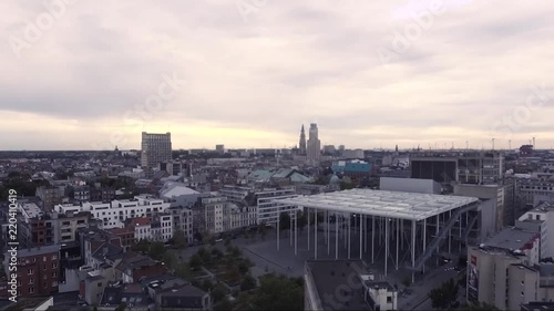 AERIAL: rising above concert hall in antwerp belgium with notre dame cathedral in the background photo