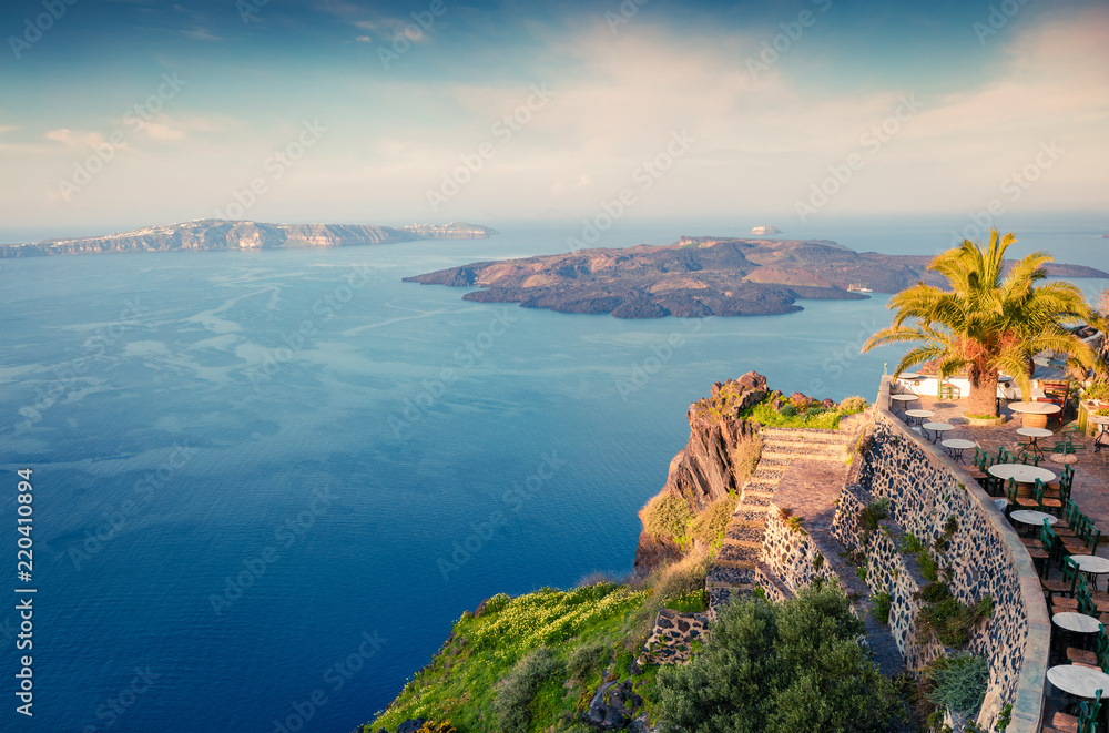 Sunny morning view of Santorini island. Picturesque spring sunrise on the famous Greek resort Thira, Greece, Europe. Traveling concept background. Artistic style post processed photo.