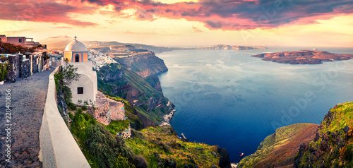 Sunny morning panorama of Santorini island. Picturesque spring sunrise on the famous Greek resort Thira, Greece, Europe. Traveling concept background. Artistic style post processed photo.
