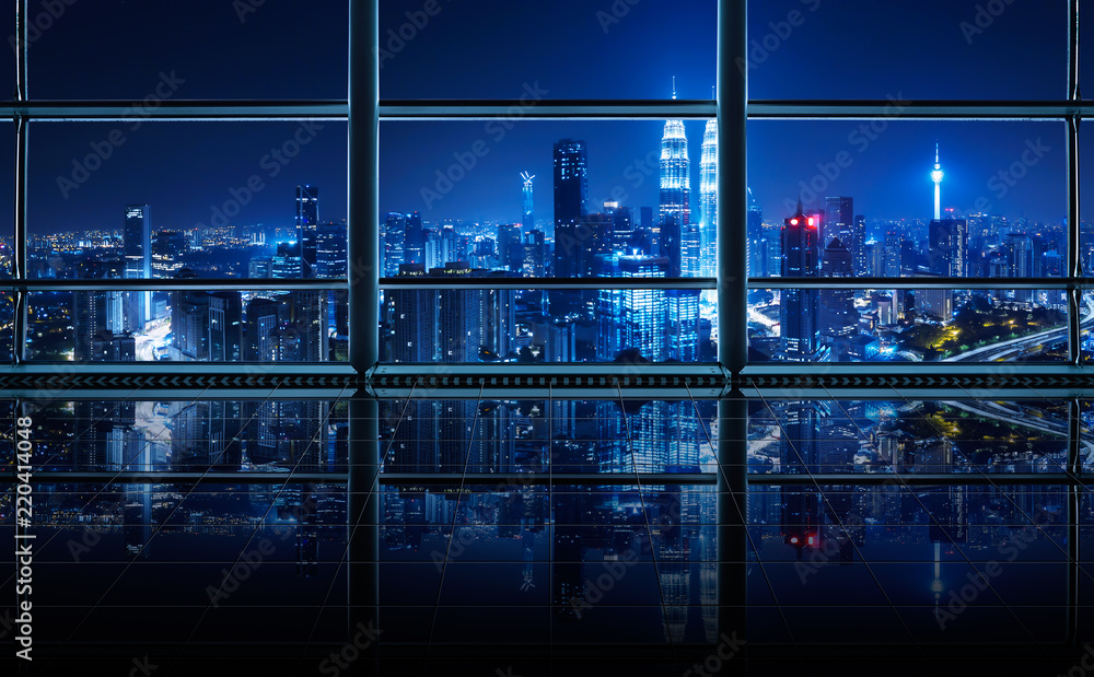 Modern empty and clean office interior with glass windows and city skyline background , night scene .
