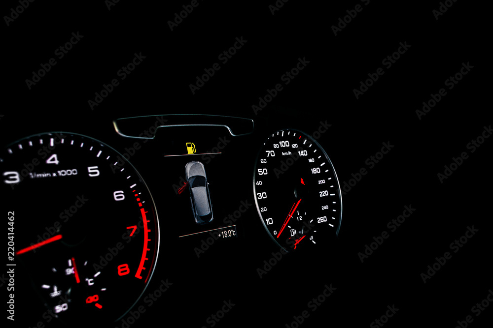Close up shot of a speedometer in a car. Car dashboard. Dashboard details with indication lamps.Car instrument panel. Dashboard with speedometer, tachometer, odometer. Car detailing. Modern interior