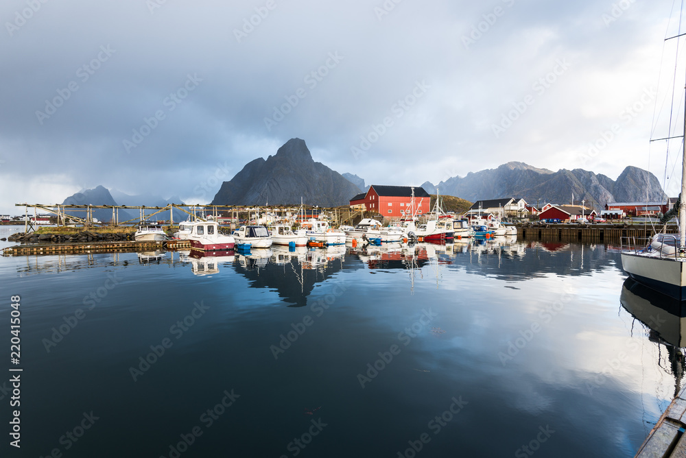 norwegian old city Reine with reflections in water and cloudy sky, norway, europe, lofots, lofoten, rorbuer