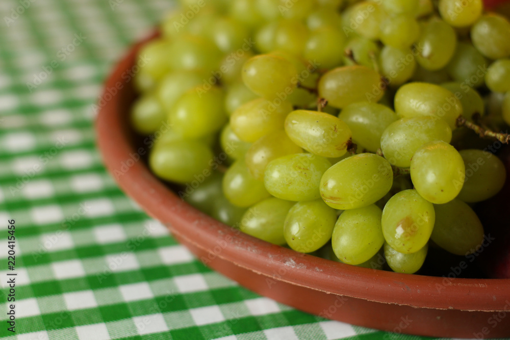 Fruit placement on white green cloth,with green grapes. Home table. Fruit placement on white green cloth,with green grapes. Home table.