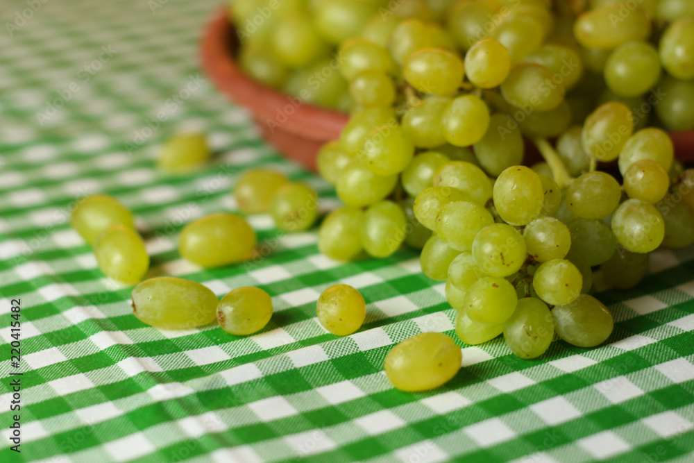 Fruit placement on white green cloth,with green grapes. Home table. Fruit placement on white green cloth,with green grapes. Home table.