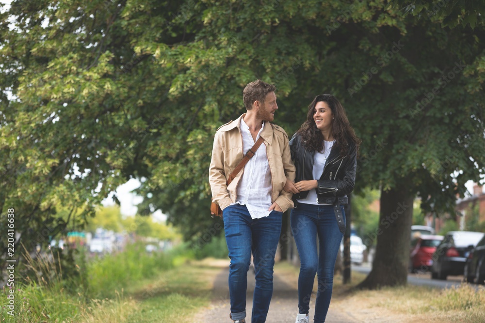 Couple interacting while walking in street Couple interacting while walking in street