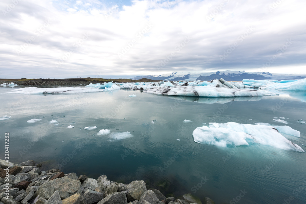 Jökulsárlón glacier lagoon with refelctions of a ice rock in the water an the glacier in the background of the jökulsarlon Jökulsárlón glacier lagoon with refelctions of a ice rock in the water an the glacier in the background of the jökulsarlon