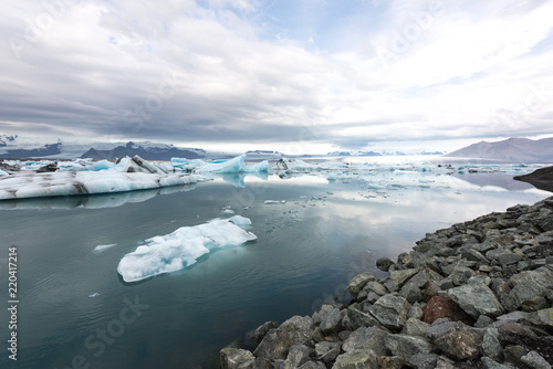 Jökulsárlón glacier lagoon with refelctions of a ice rock in the water an the glacier in the background of the jökulsarlon photo