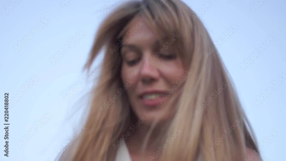 street portrait of a cute middle-aged girl in a white dress looks down street portrait of a cute middle-aged girl in a white dress looks down