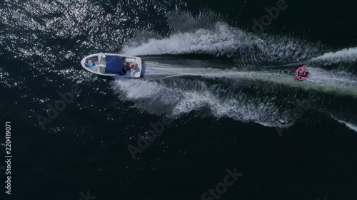 A guy is tubing with a speed boat on a lake in North Carolina. photo