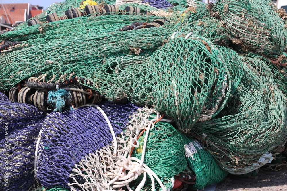 Fisherman's net are drying on the quay in the harbor of Urk in Netherlands.