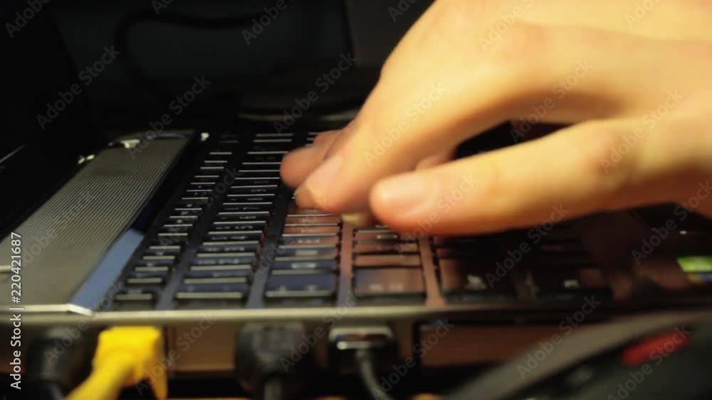 Fingers typing on a laptop with a back lit keyboard. Fingers typing on a laptop with a back lit keyboard.