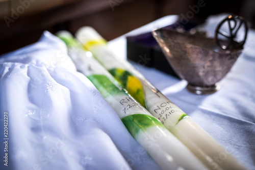 Fotografi baptismal candle from christian catholic baptism, handmade candles, with holy wa