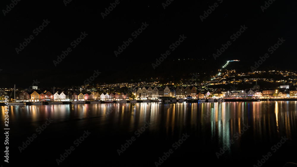 Bergen norway brygge by night with reflection in the water, norway, europe