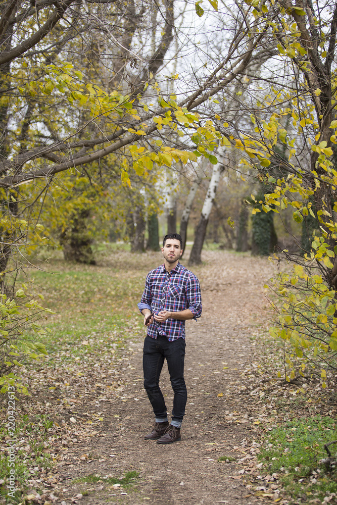 young handsome man in nature ,autumn .serious thoughts young handsome man in nature ,autumn .serious thoughts