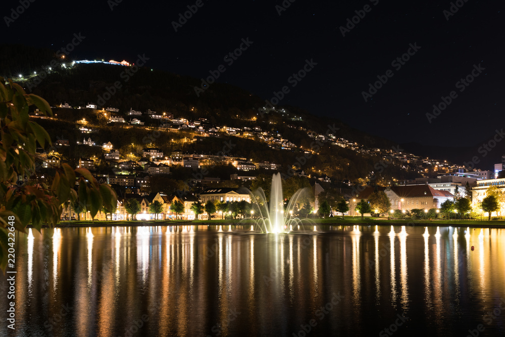 Bergen norway brygge by night with reflection in the water, norway, europe with floyen