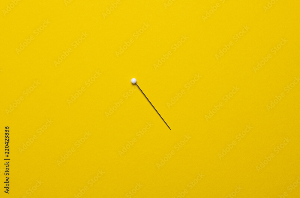 white ball pin on yellow background white ball pin on yellow background