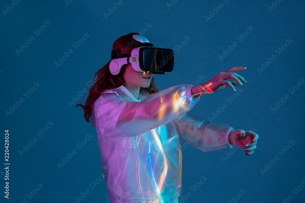 Woman touching air in VR glasses Woman touching air in VR glasses