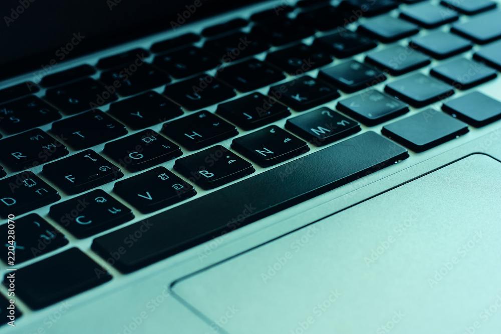 Selective focus of computer keyboard of English and Thai language with dark tone and added color filter for business and technology concept Selective focus of computer keyboard of English and Thai language with dark tone and added color filter for business and technology concept