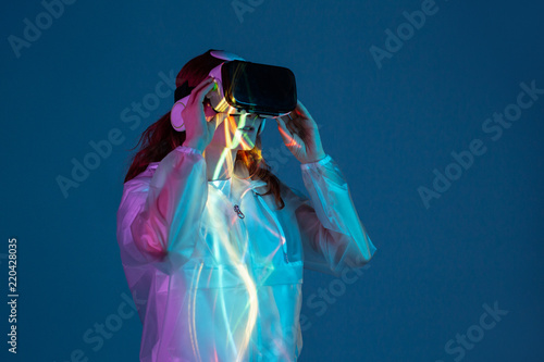 Woman touching air in VR glasses photo