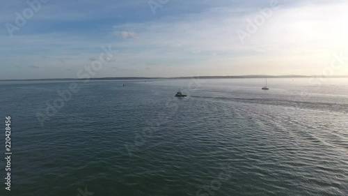 Wallpaper Mural 4K Aerial of small tub boat passing calshot near Southampton in the solent. Torontodigital.ca