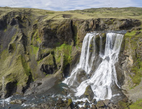 View on Beautiful Fragifoss waterfall on Geirlandsa river in South Iceland photo