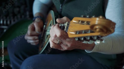Close up of woman playing ornate mandolin photo
