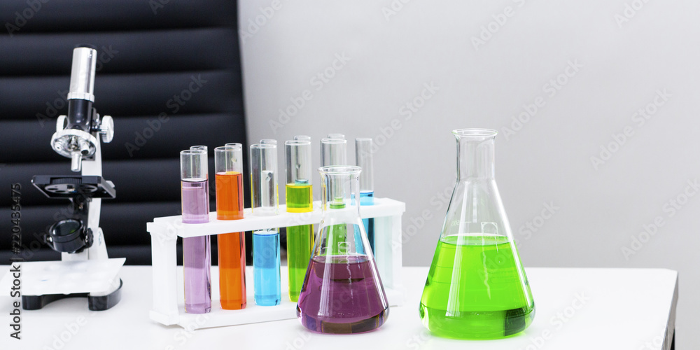 Color water in test tube,microscopes and beaker.Copy space on white science lab. Color water in test tube,microscopes and beaker.Copy space on white science lab.