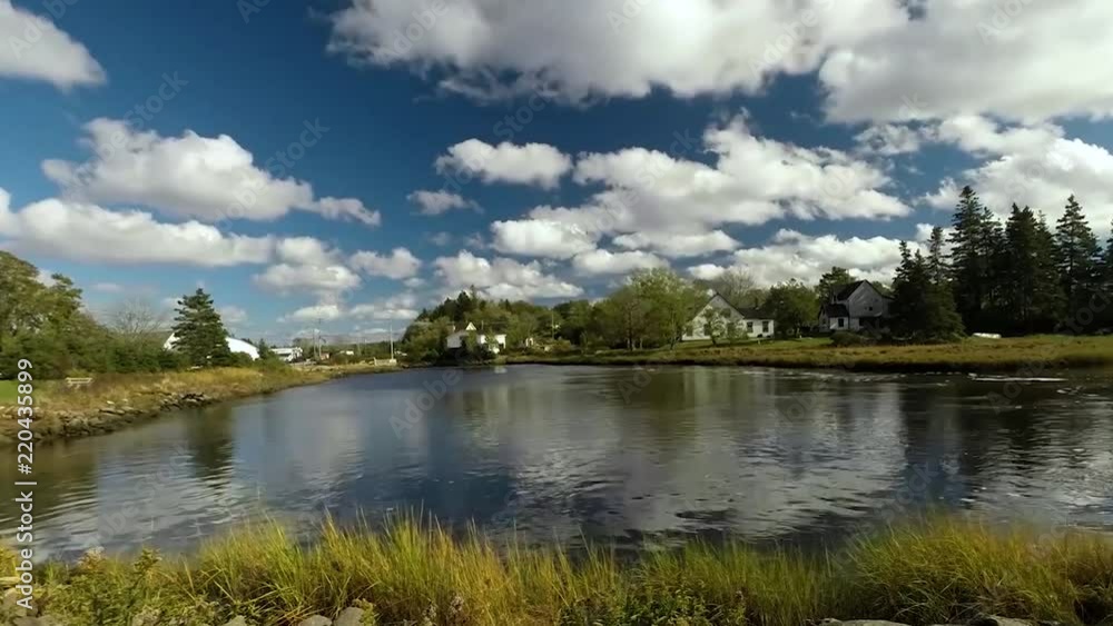 Stunning ,fluffy clouds floating over a serene river Stunning ,fluffy clouds floating over a serene river