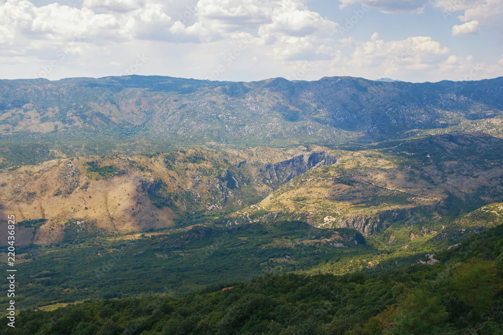 Mountain summer landscape. Montenegro, Dinaric Alps, view of Bjelopavlici plain near Ostrog monastery Mountain summer landscape. Montenegro, Dinaric Alps, view of Bjelopavlici plain near Ostrog monastery