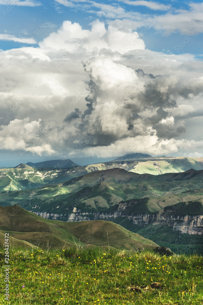 Gray cumulus clouds in the mountains before the rain. Mountains of the Caucasus in the concept of weather