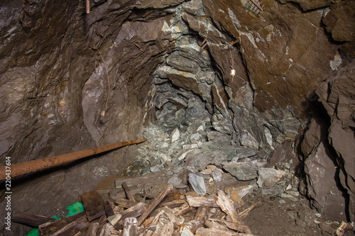 Underground abandoned gold iron ore mine shaft tunnel gallery passage with timbering wooden